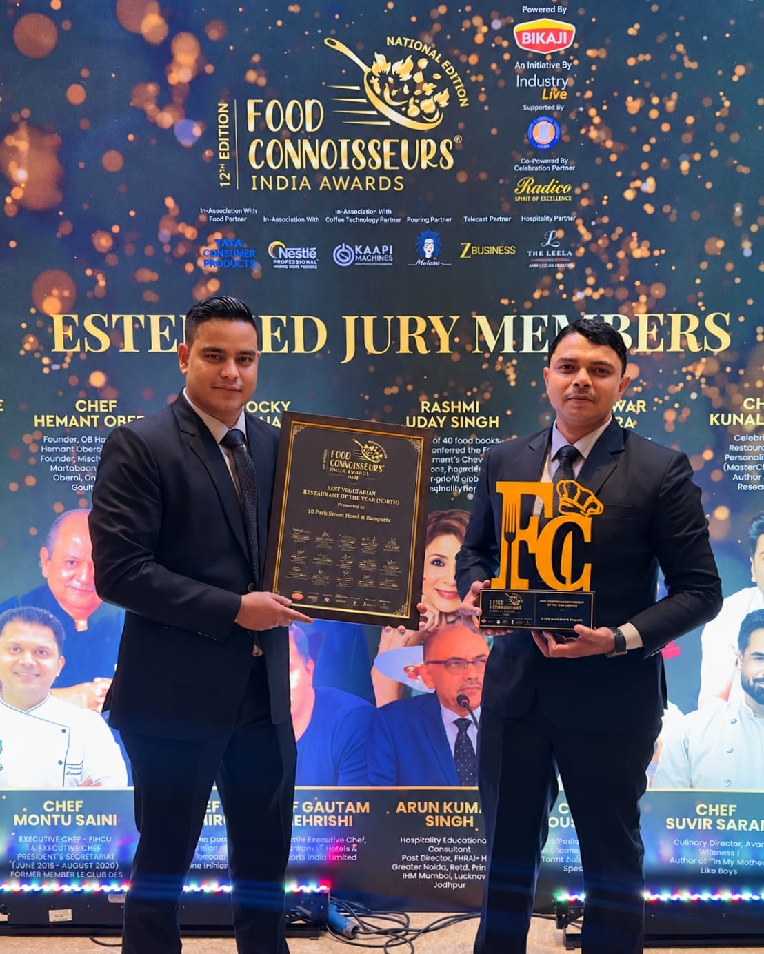 Two representatives of 10 Park Street holding the award certificate and trophy at the Food Connoisseurs India Awards 2026