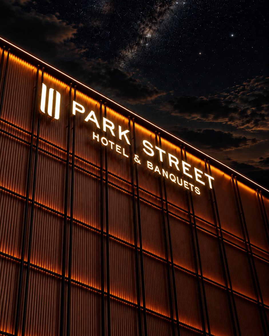 Illuminated exterior sign for 10 Park Street Hotel & Banquets at dusk